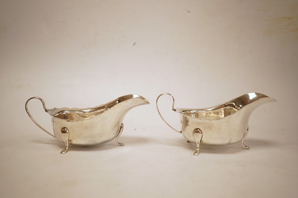 A pair of 1930's silver sauceboats, with cut borders, Barker Brothers Silver Ltd, Birmingham, 1935 and 1938, length 14.6cm, 5.8oz.
